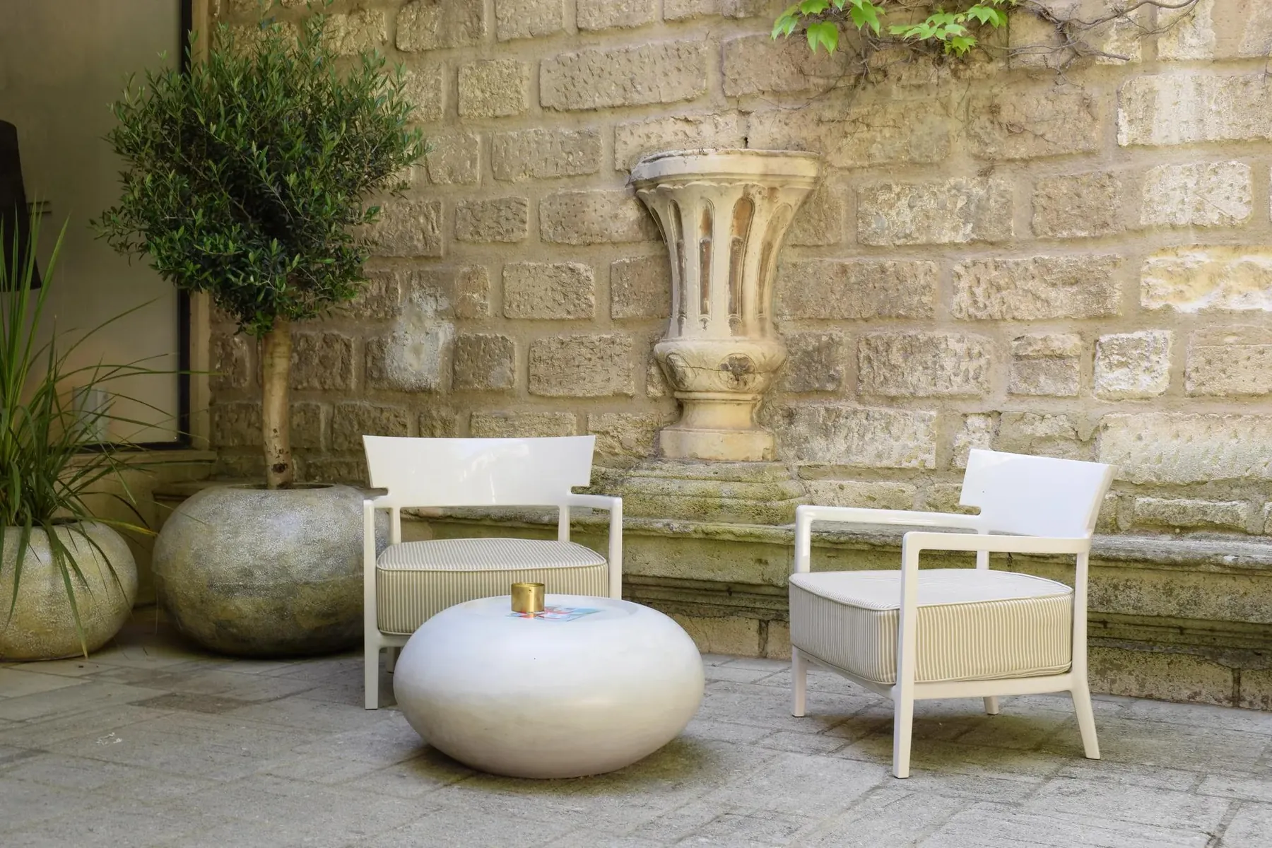 La cour de pierre, fauteuils blancs et olivier